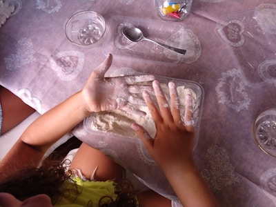 a little girl that is laying down on a table