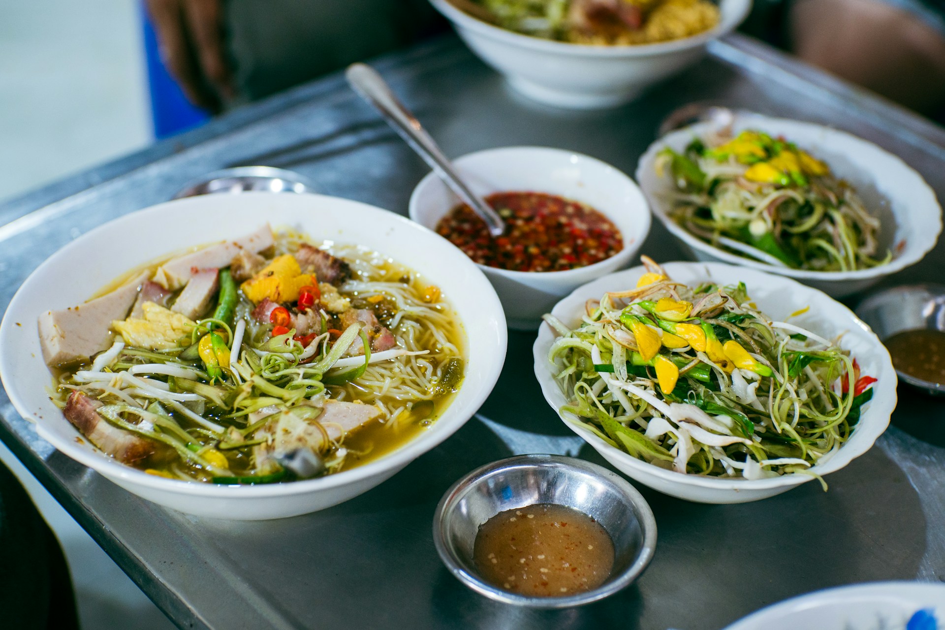A vibrant selection of colorful side dishes, including crispy fries and fresh salads, arranged in appealing bowls.