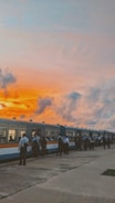 Photo of a couple boarding the Regiotram train at sunset.
