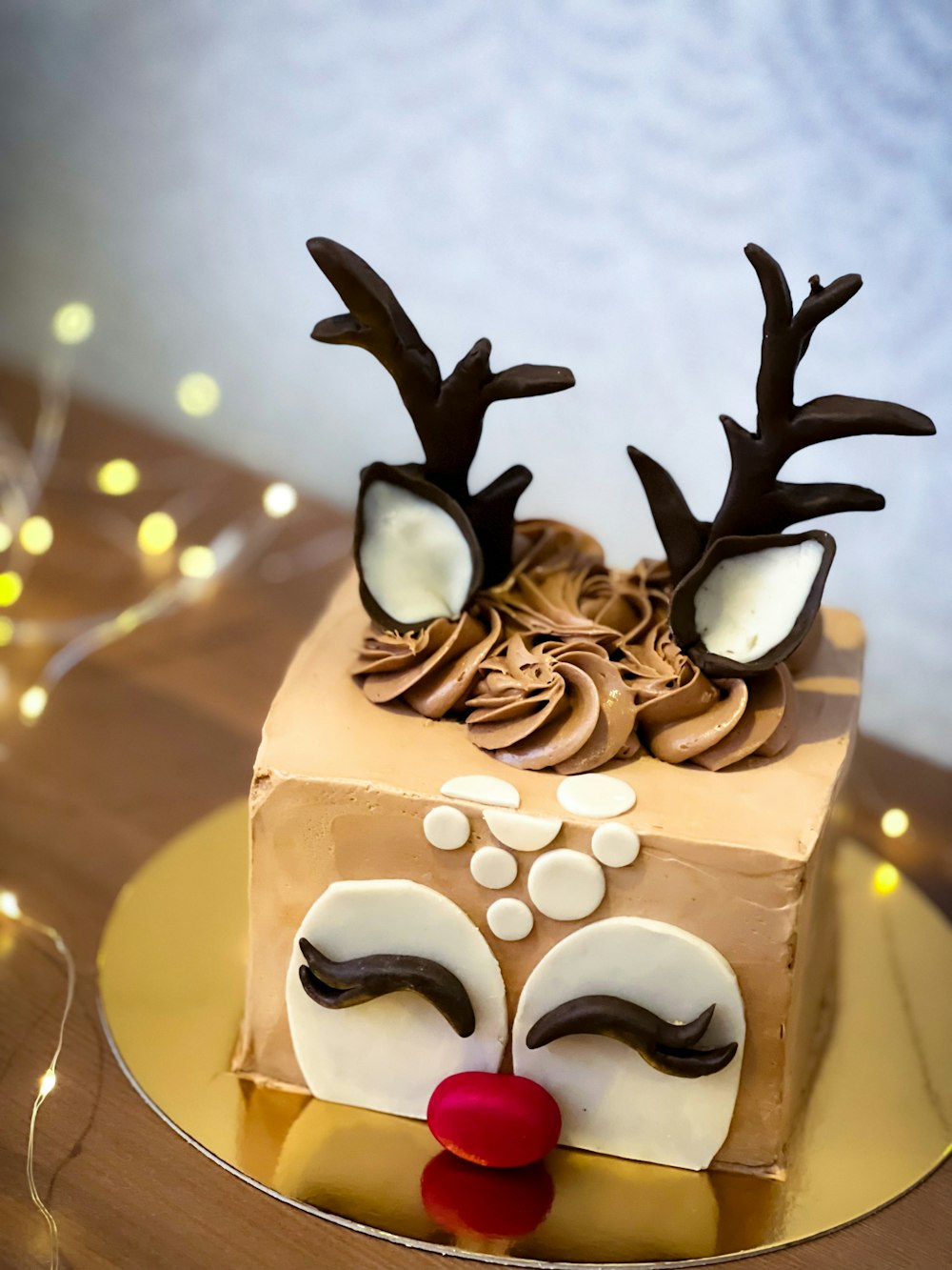 a cake decorated with chocolate icing and decorated with reindeer noses