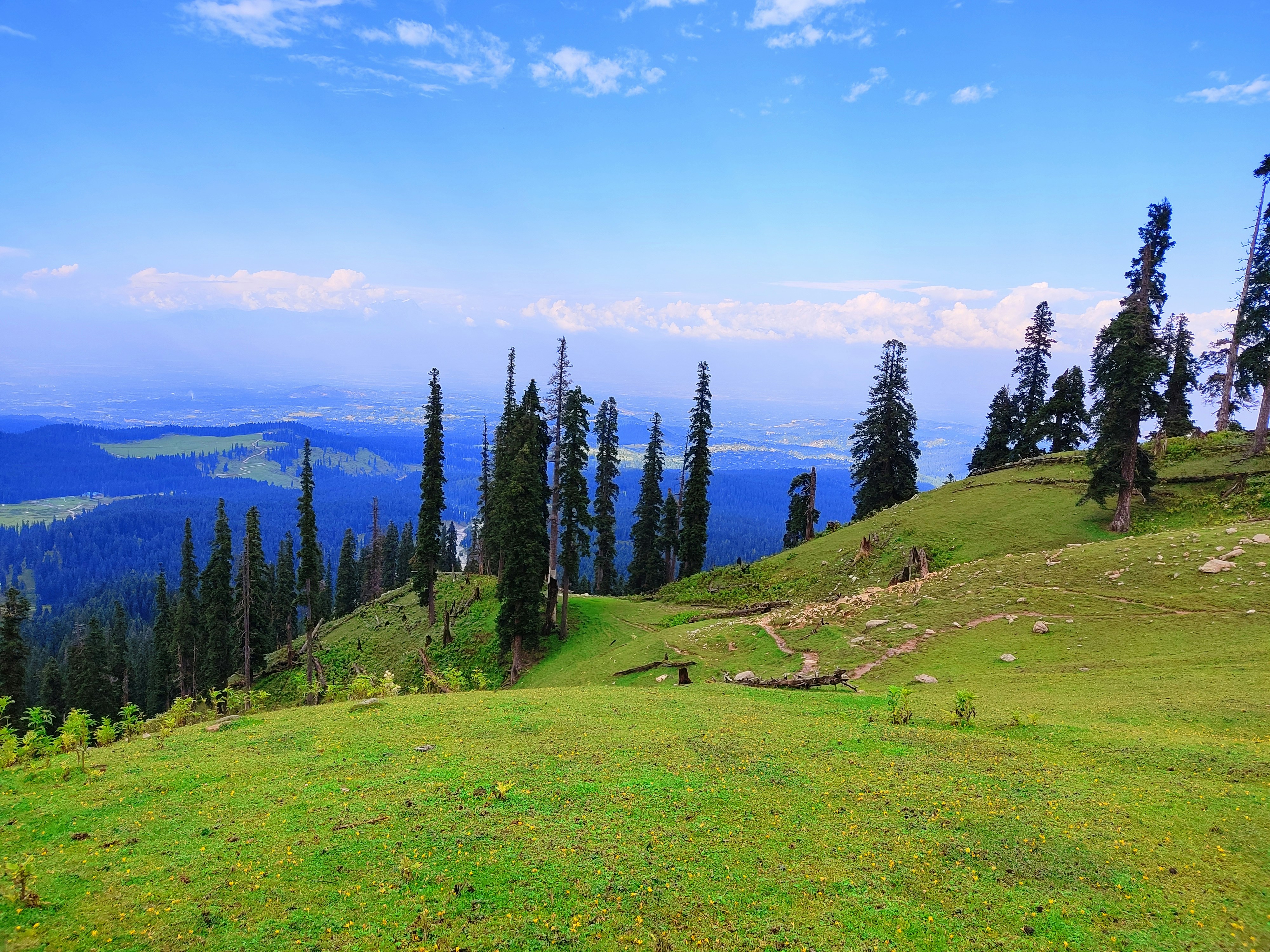 Grassland landscape with clouds in blue sky and meadows after rainfall in doodhpathri valley of Kashmir india