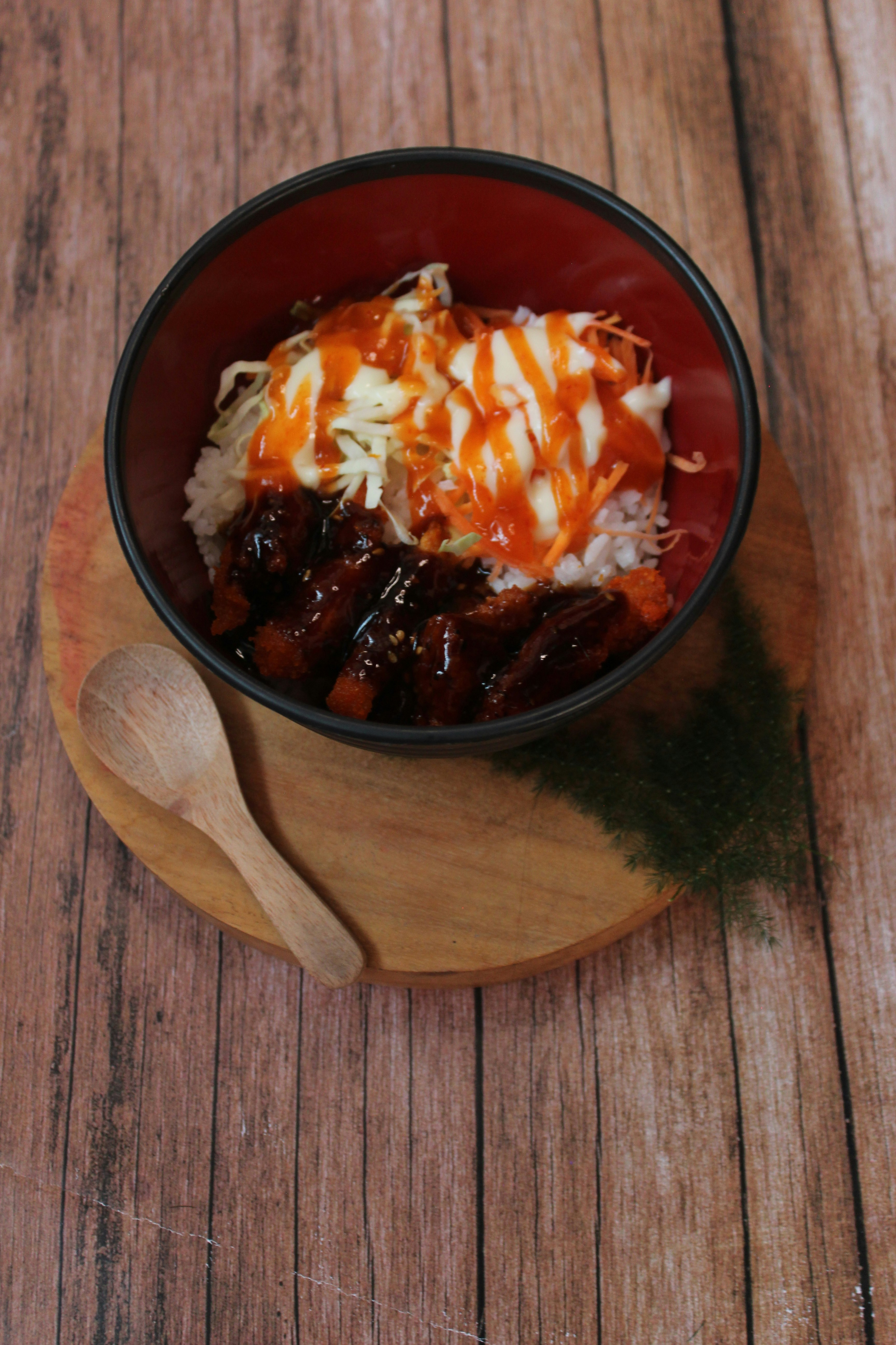 a bowl of food sitting on top of a wooden table