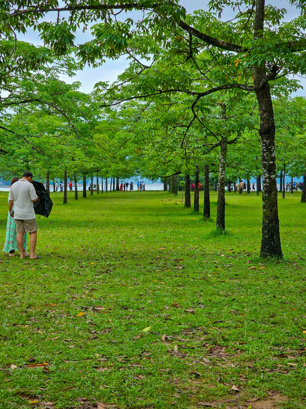 a man and a woman walking through a park