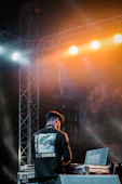 a man standing on a stage with a laptop