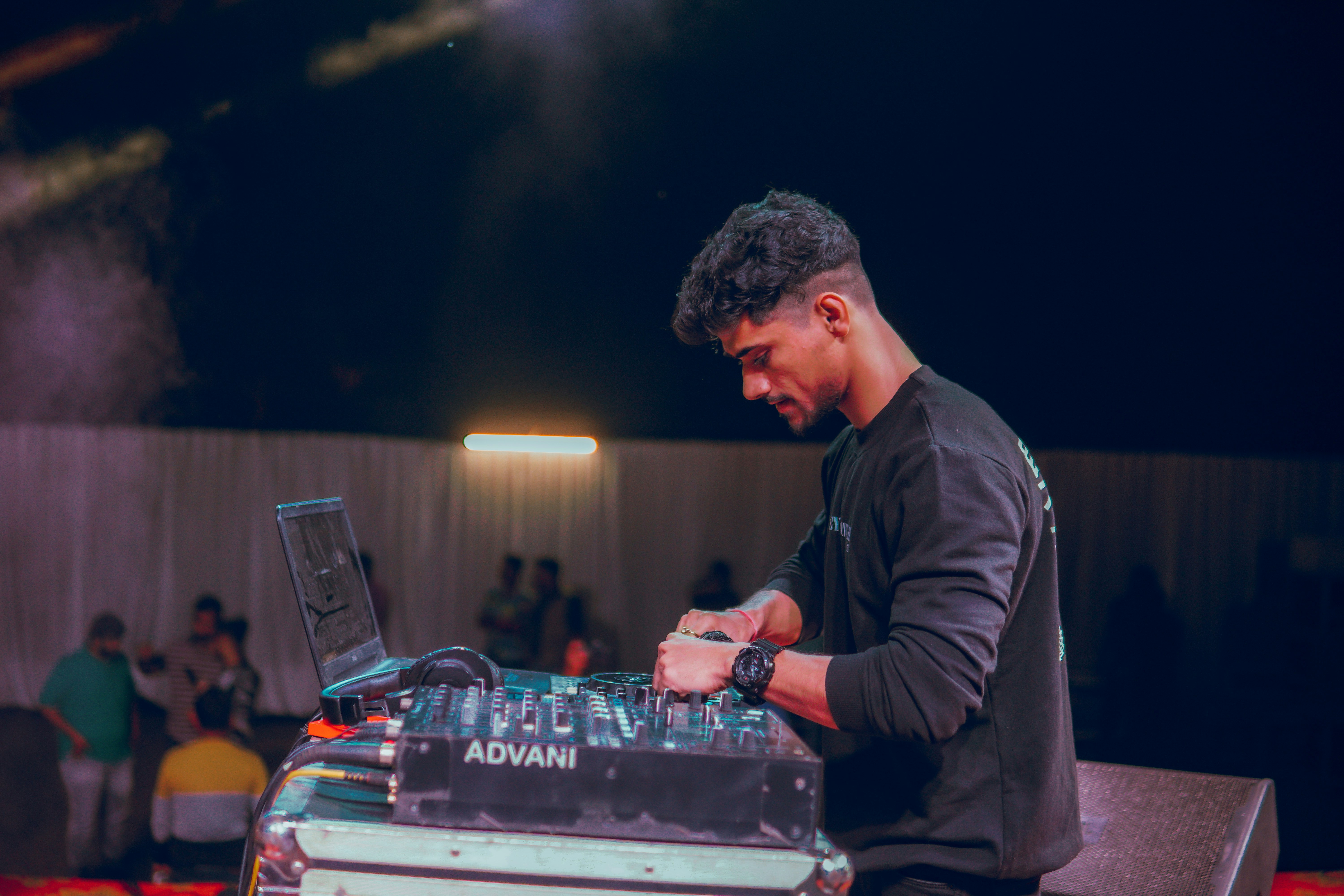a man that is sitting at a dj's desk