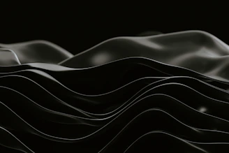 A minimalist, elegant sound wave gently flowing over a dark, textured background.