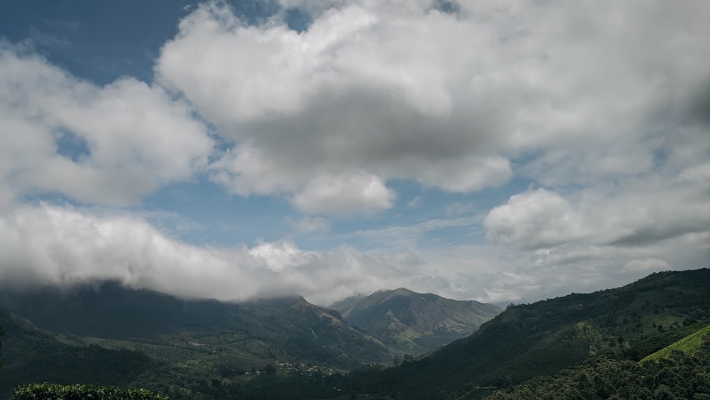 a view of a mountain range with clouds in the sky