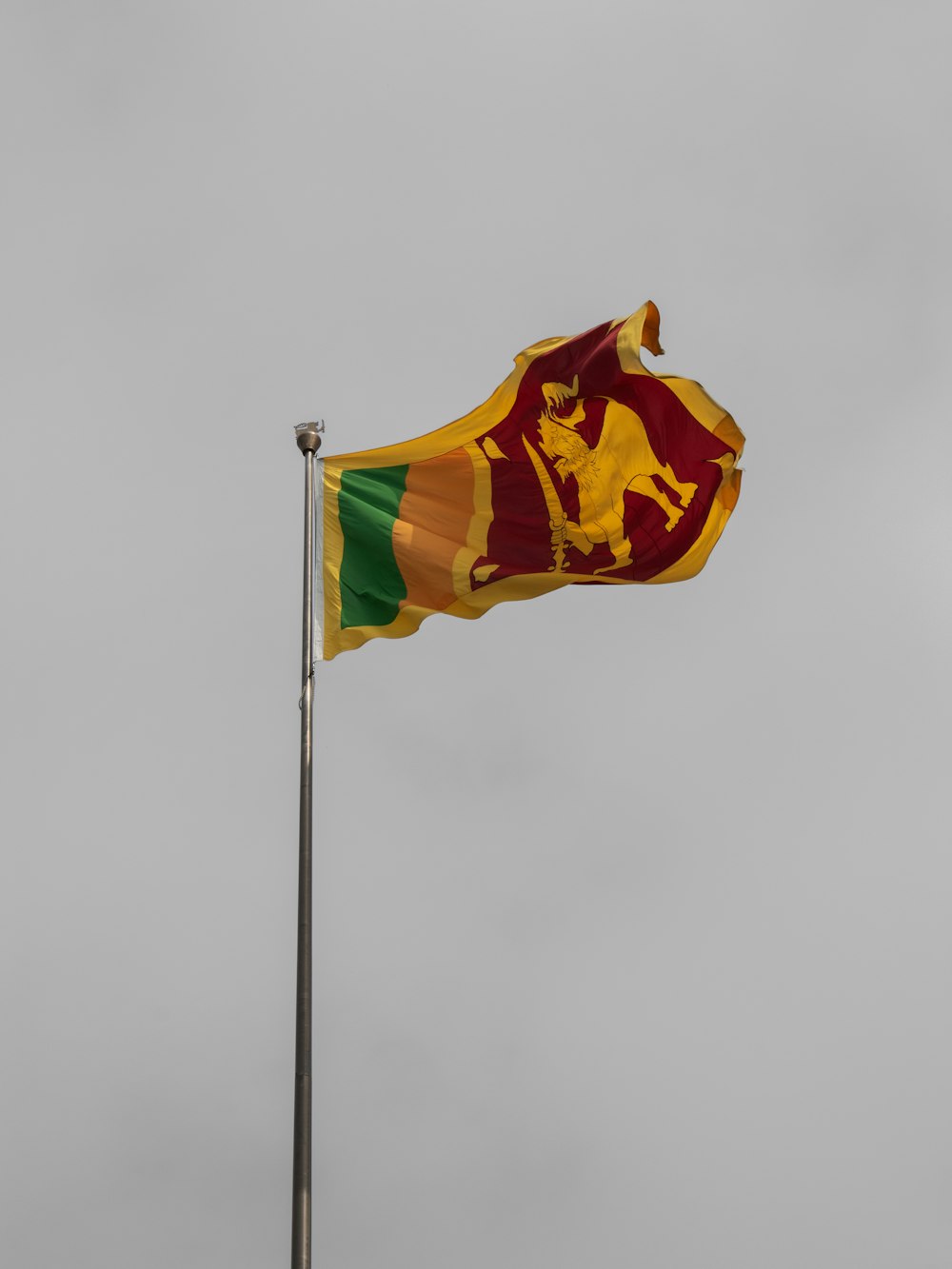 a flag flying in the wind on a cloudy day