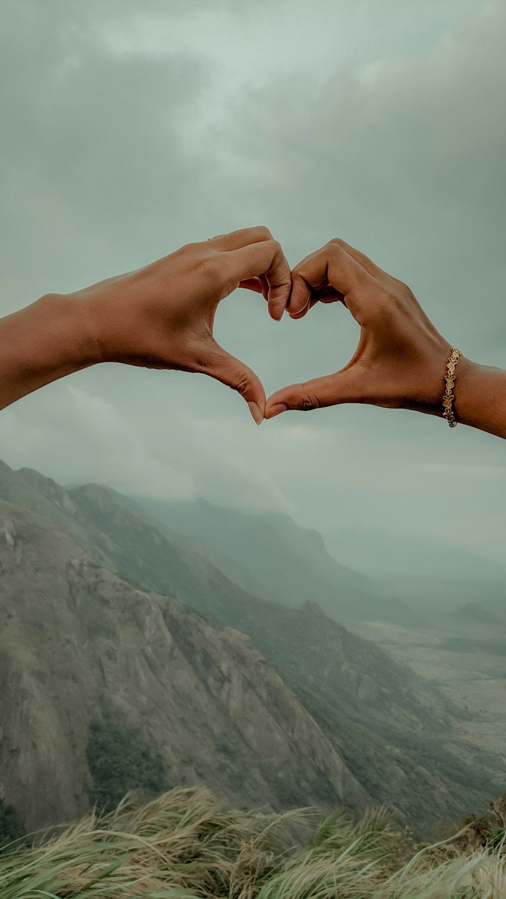 two hands making a heart shape with their fingers