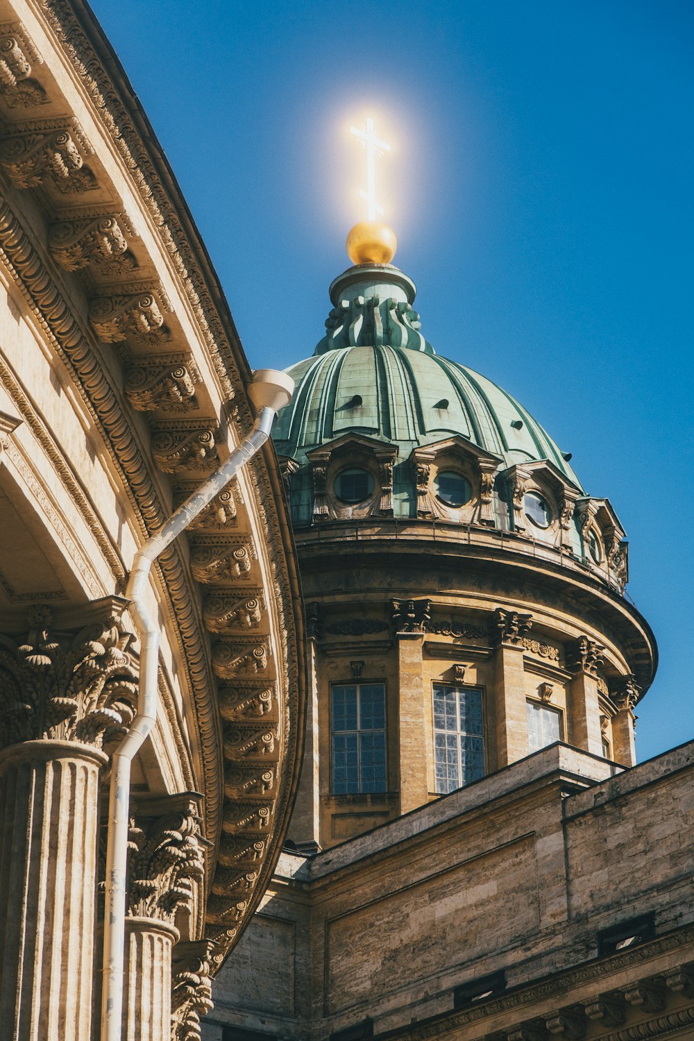 a tall building with a green dome on top