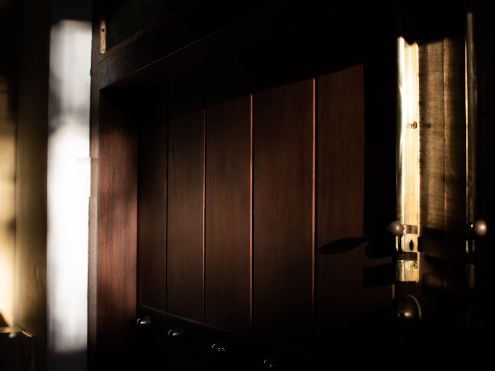a wooden door with a light coming through it