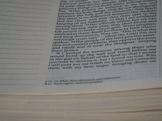 Close-up of a person annotating a dense academic text with a pen.
