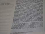 A close-up of a book with notes, symbolizing research in omnitology.
