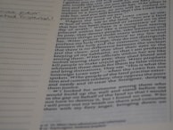 A student taking notes during a virtual lecture on theology.