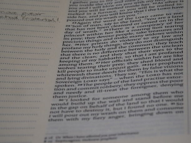 Close-up of an open book showing detailed Aramaic script and notes in the margins.