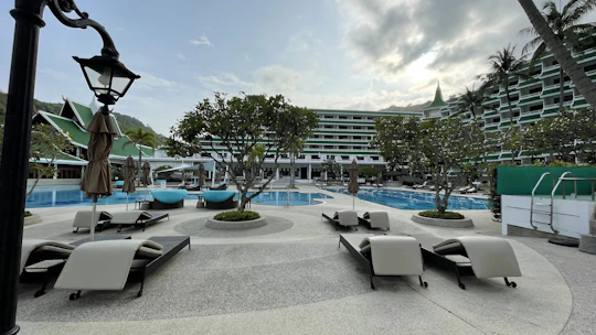 Luxurious hotel pool area with modern design and comfortable lounge chairs.