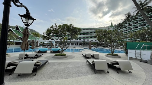 Close-up of a stylish resort poolside lounge area with gold accents.