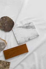 a white sheet with marble and wood on it