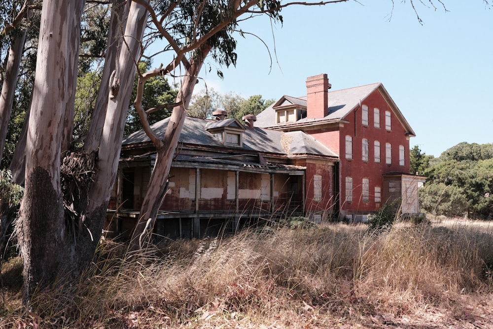 an old abandoned house in the middle of a field