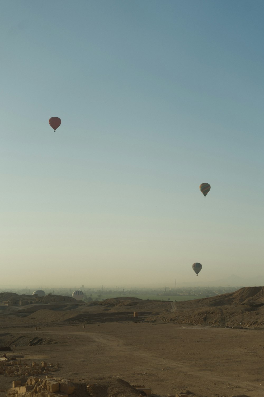 a group of hot air balloons flying in the sky