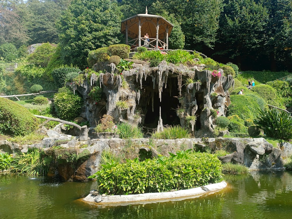 a small island in a pond surrounded by trees