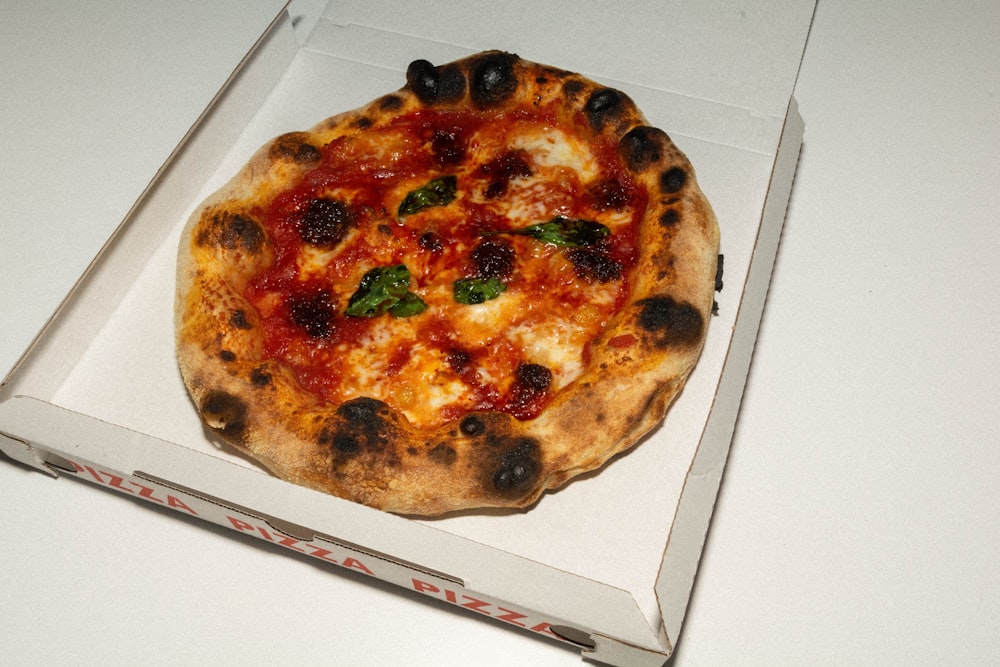 a pizza sitting inside of a box on a table