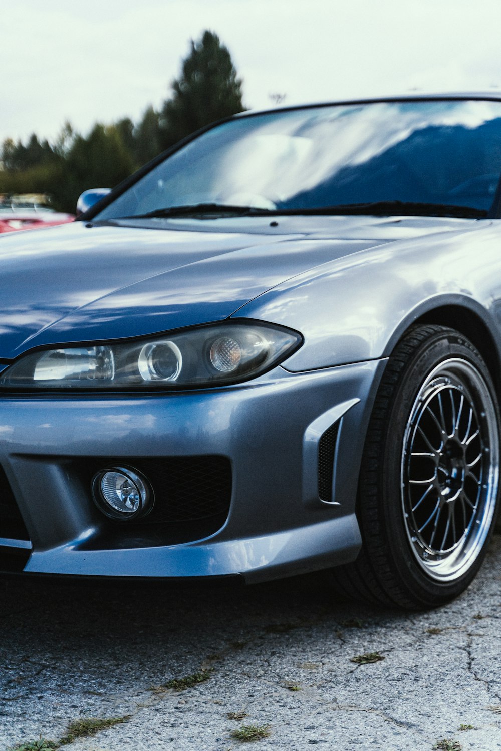 a silver sports car parked in a parking lot