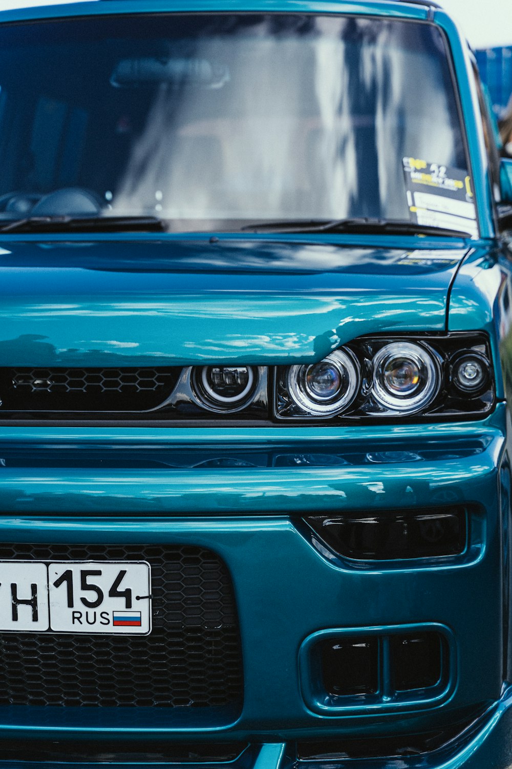 a close up of the front of a blue car