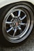 a close up of a wheel on a white car