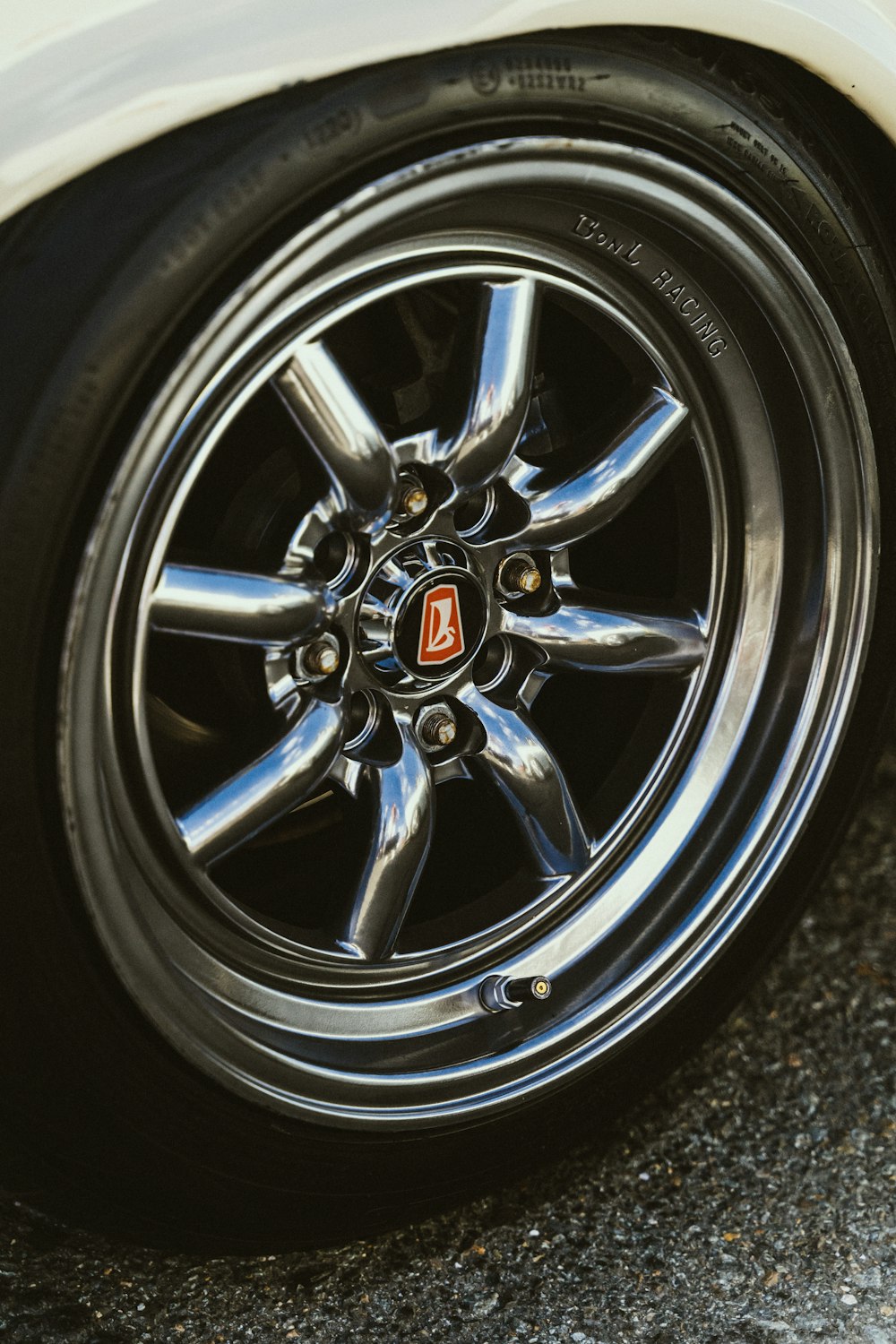 a close up of a wheel on a white car