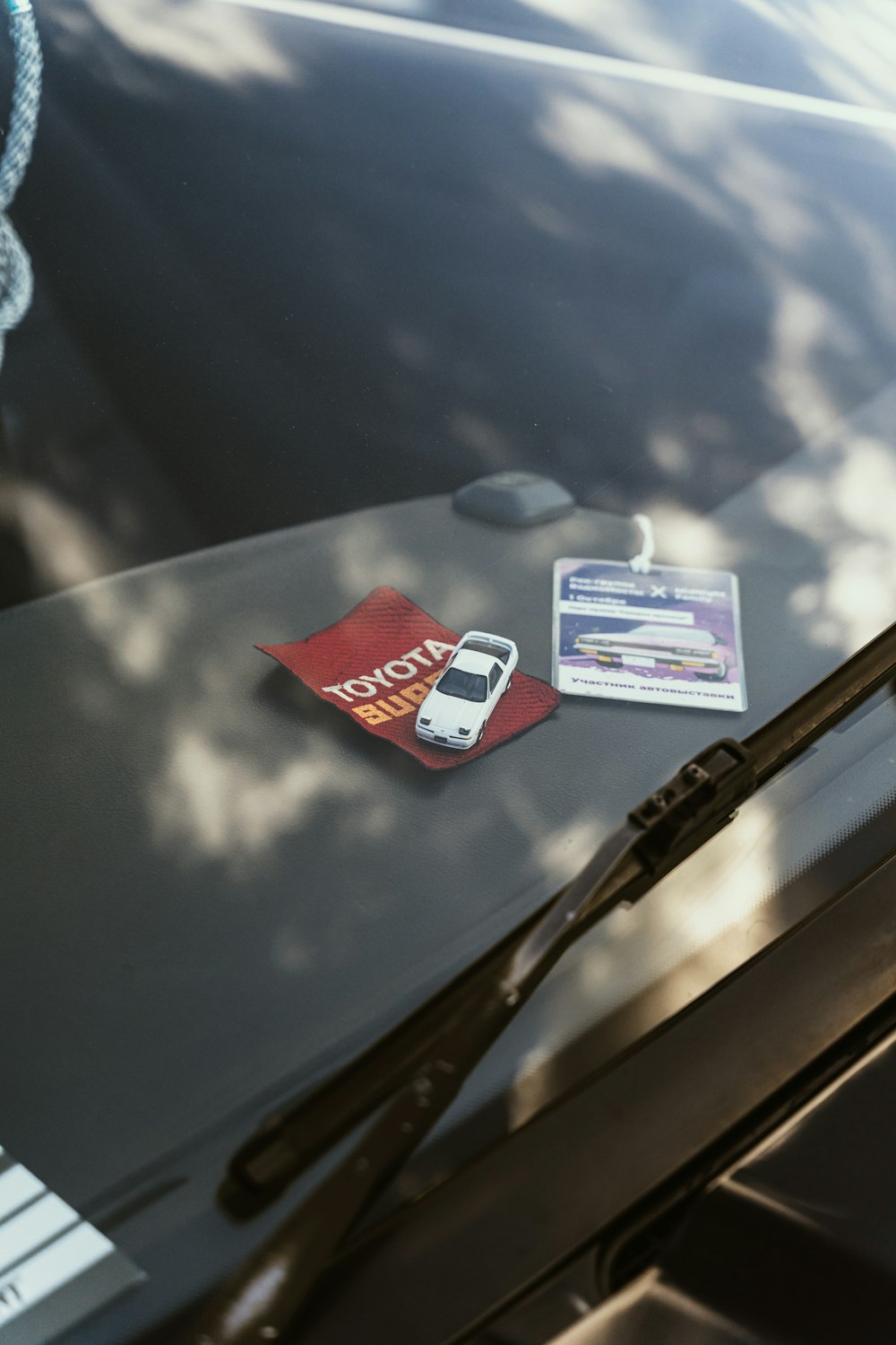 a car with a parking ticket and a cell phone on the windshield