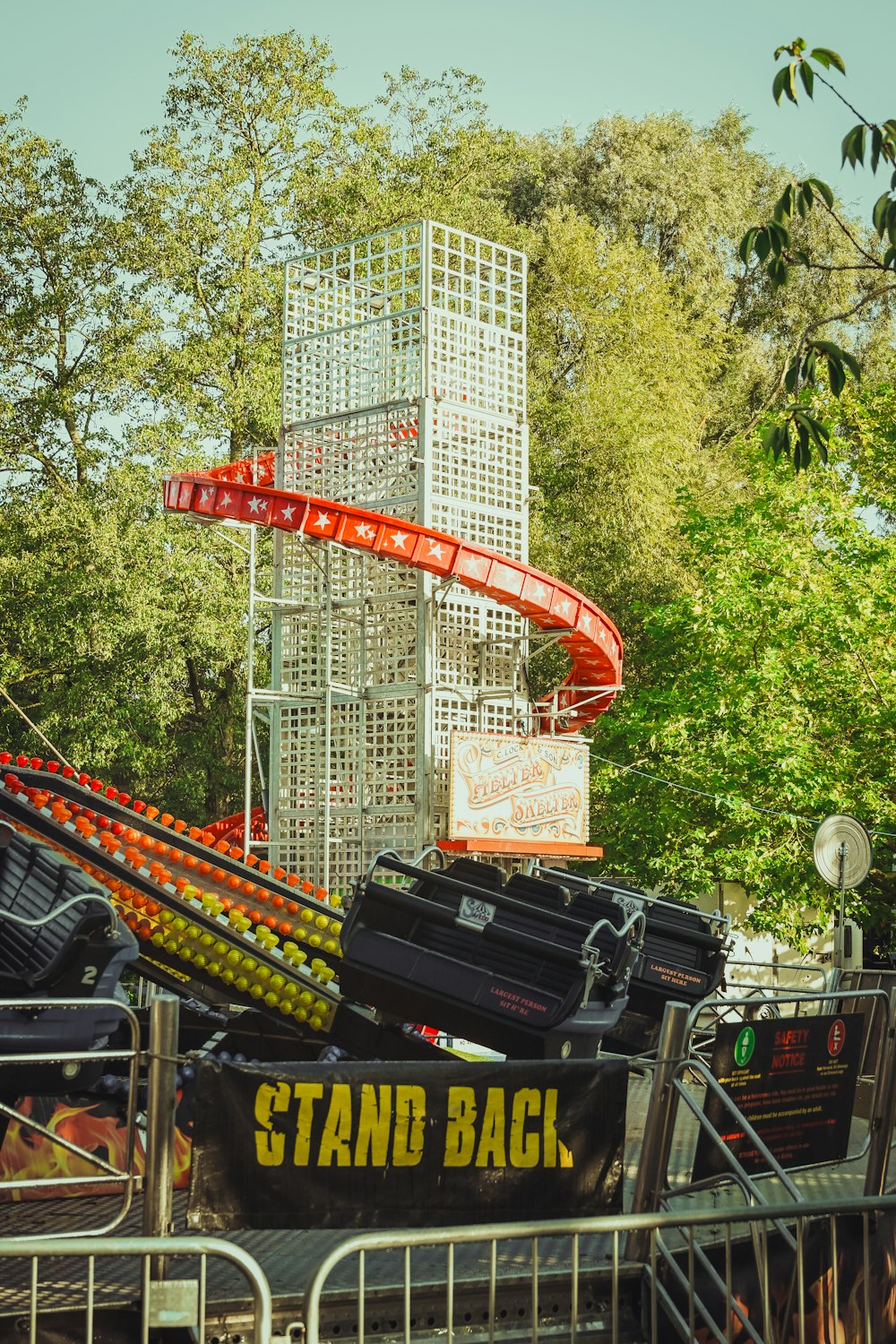 a roller coaster at a theme park with luggage on it