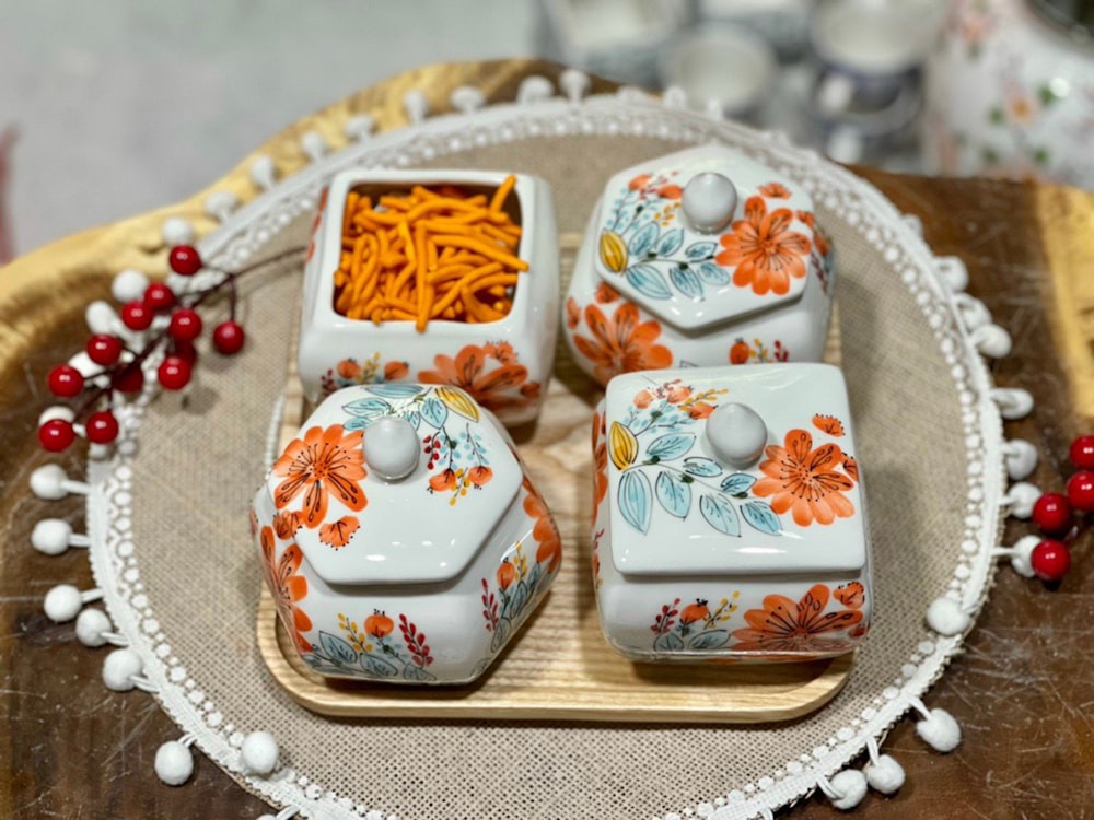 a wooden tray topped with four ceramic dishes