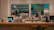A cozy coffee shop interior featuring a long wooden counter, modern art on the walls, and plants adding a touch of greenery.