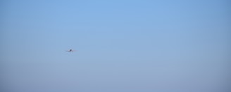 Airplane flying in a clear blue sky.