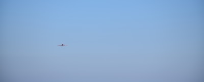 Airplane flying in a clear blue sky.