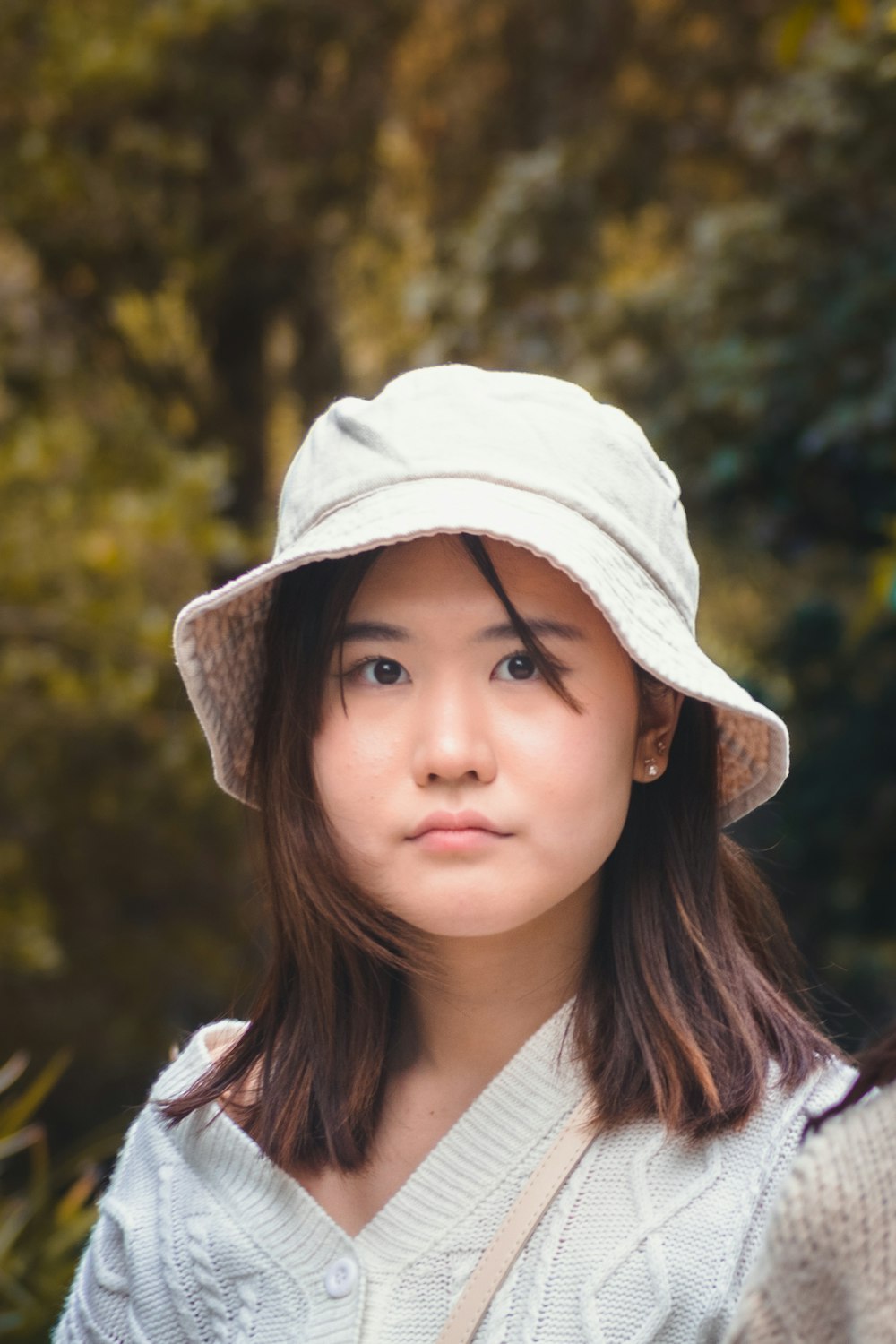 a woman wearing a white hat and a sweater