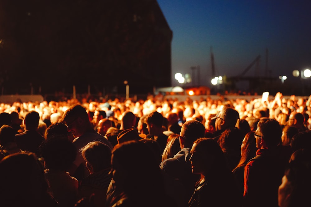 a large group of people standing around each other