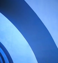 Abstract subtle upward financial growth lines in deep navy and steel blue tones forming a modern pattern.