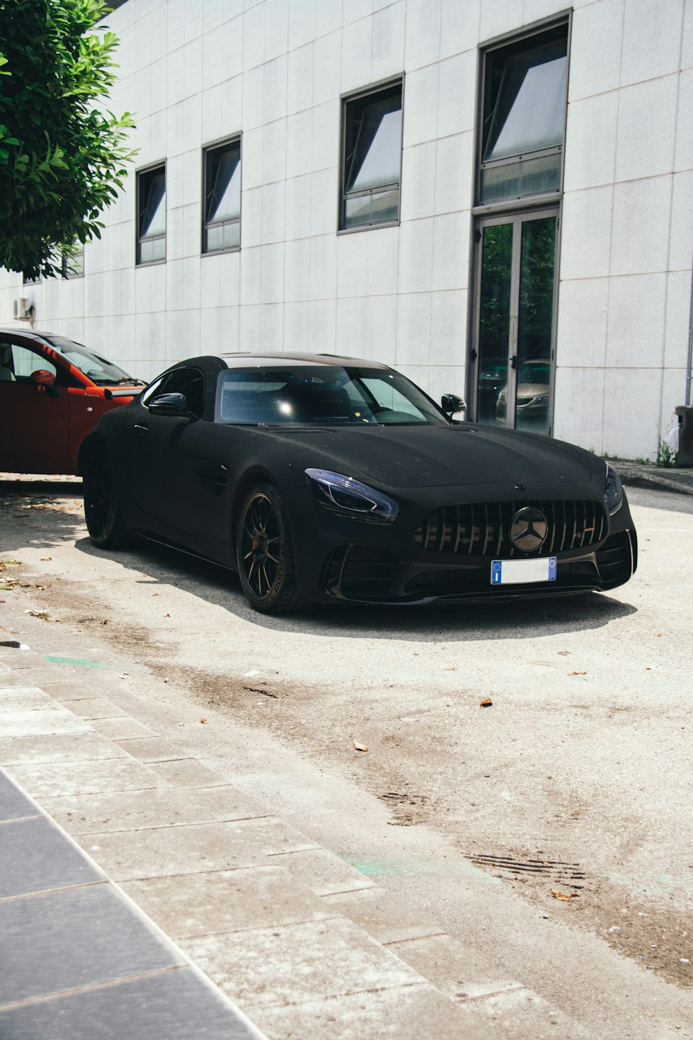 a black sports car parked in front of a building