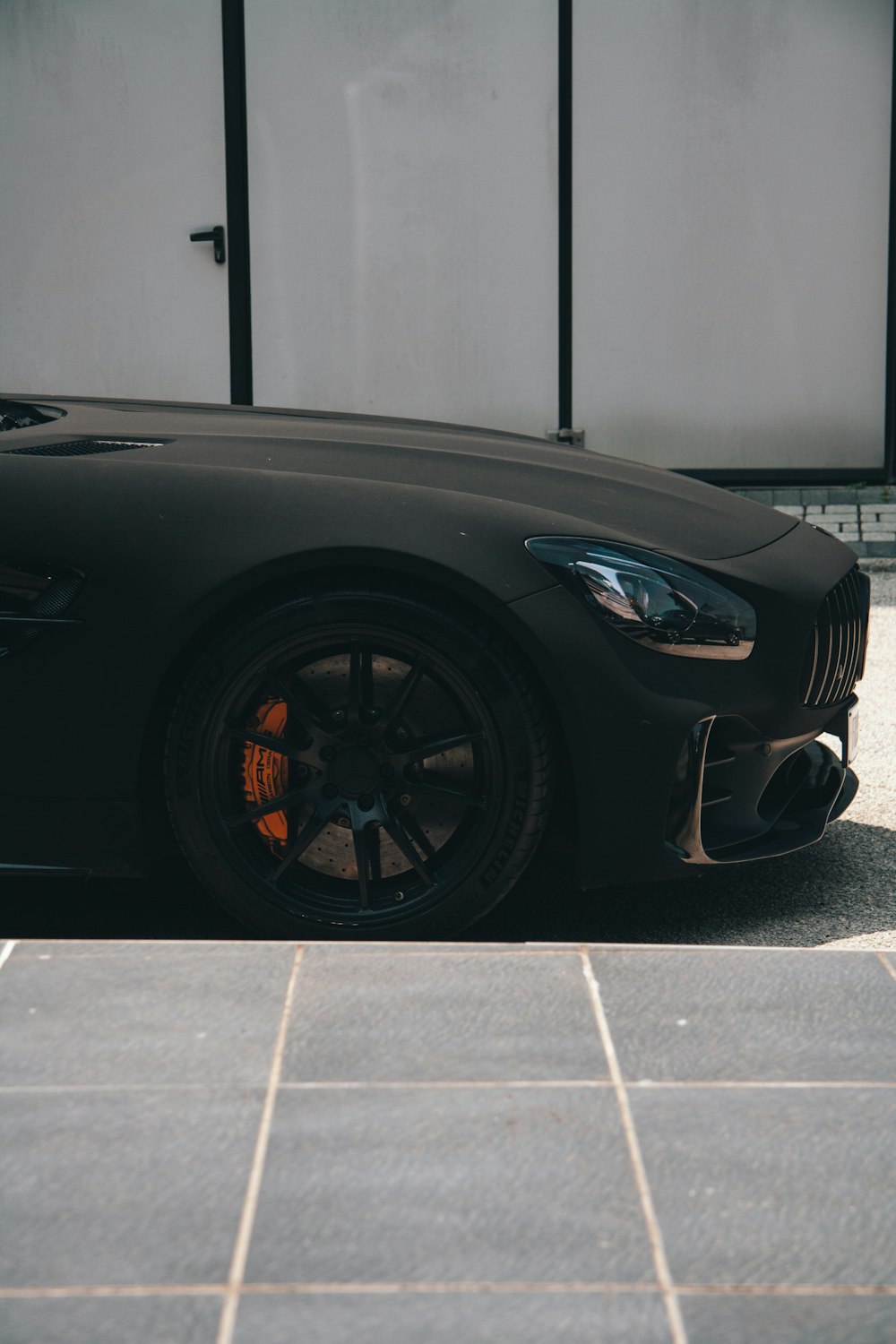 a black sports car parked in front of a building