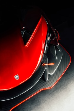 Close-up of a sleek race car's aerodynamic wing under studio lighting