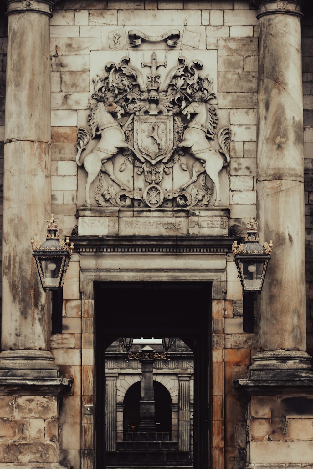 a large building with a doorway and a clock on the front of it