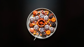 a white plate topped with lots of halloween candies