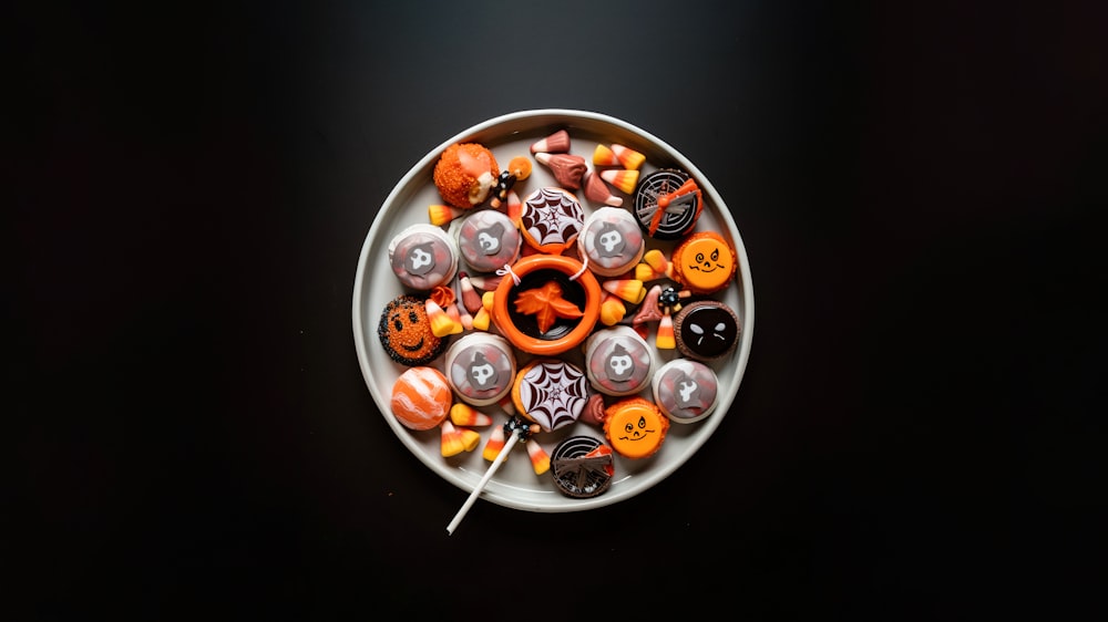 a white plate topped with lots of halloween candies