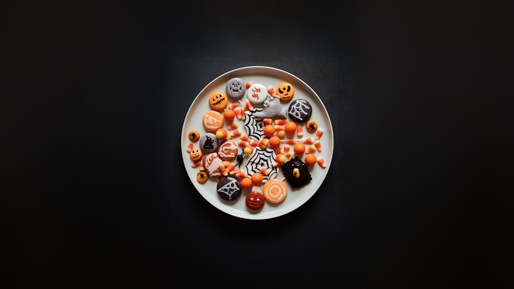 a white plate topped with lots of halloween candies
