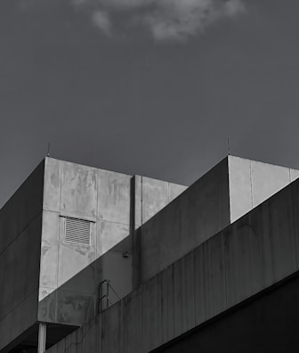 Photo of a minimalist roster beton ventilasi integrated into a sleek modern building facade.