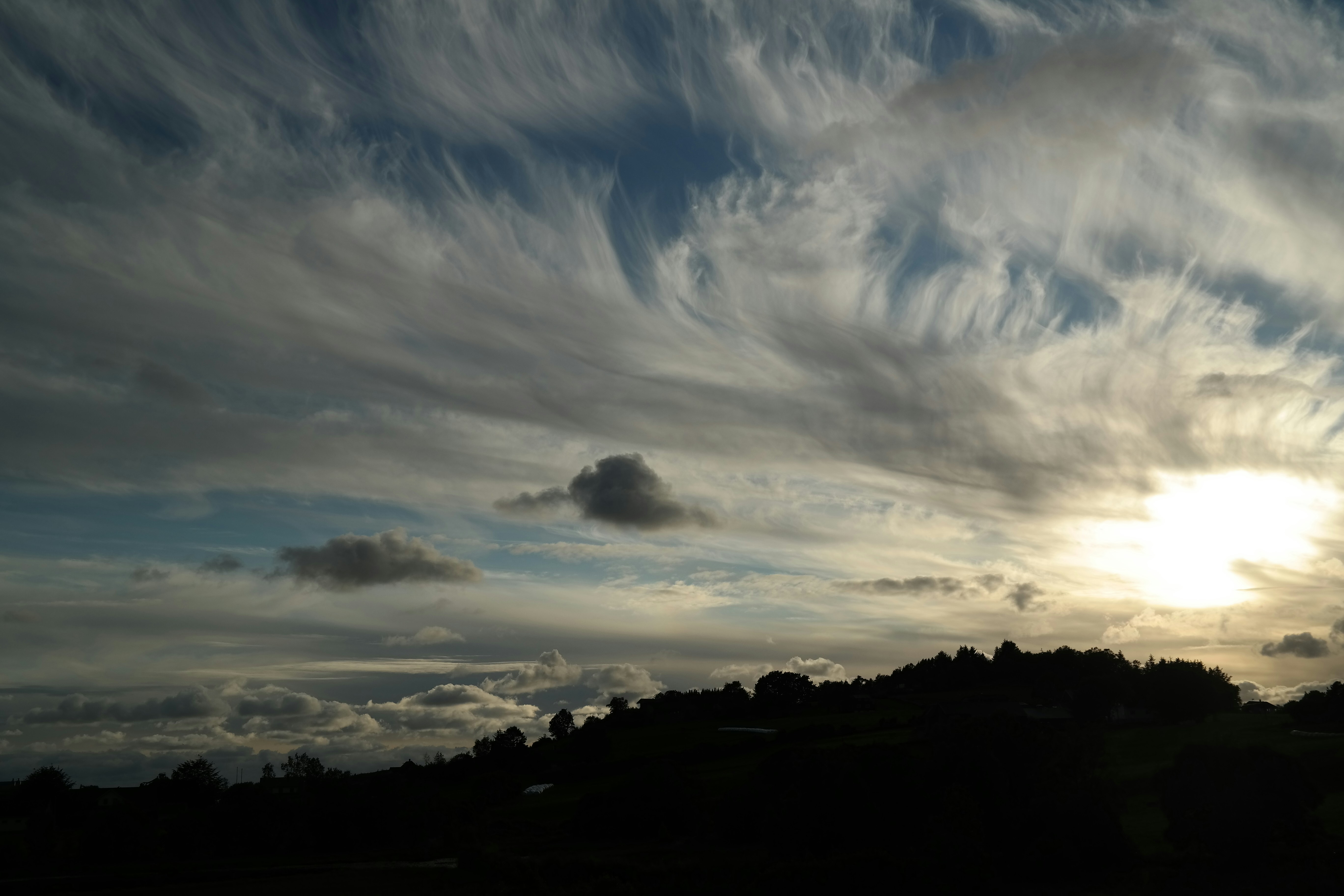 the sun is shining through the clouds in the sky