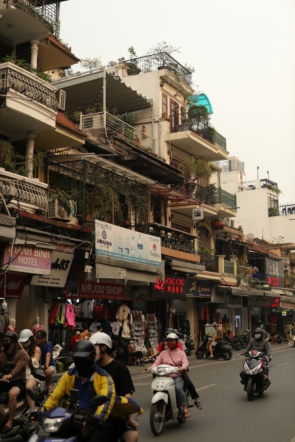 a group of people riding motorcycles down a street