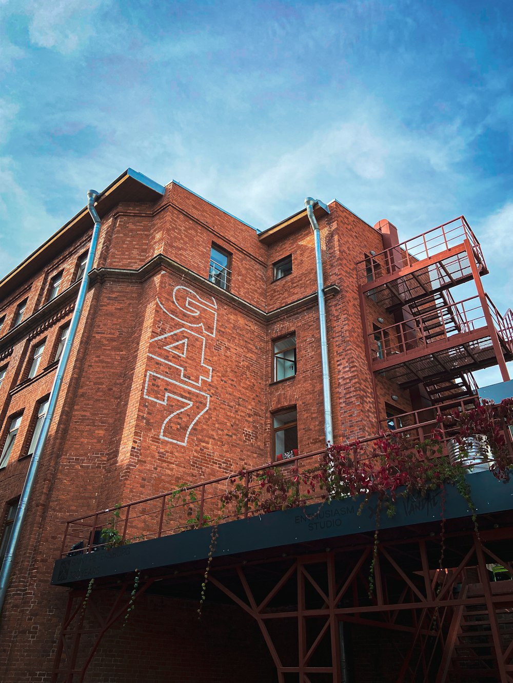 a tall brick building with graffiti on the side of it